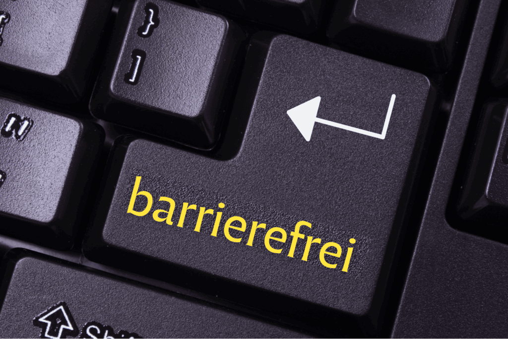 Die Enter Tast einer schwarzen Tastatur. Darauf steht gelb das Wort barrierefrei.